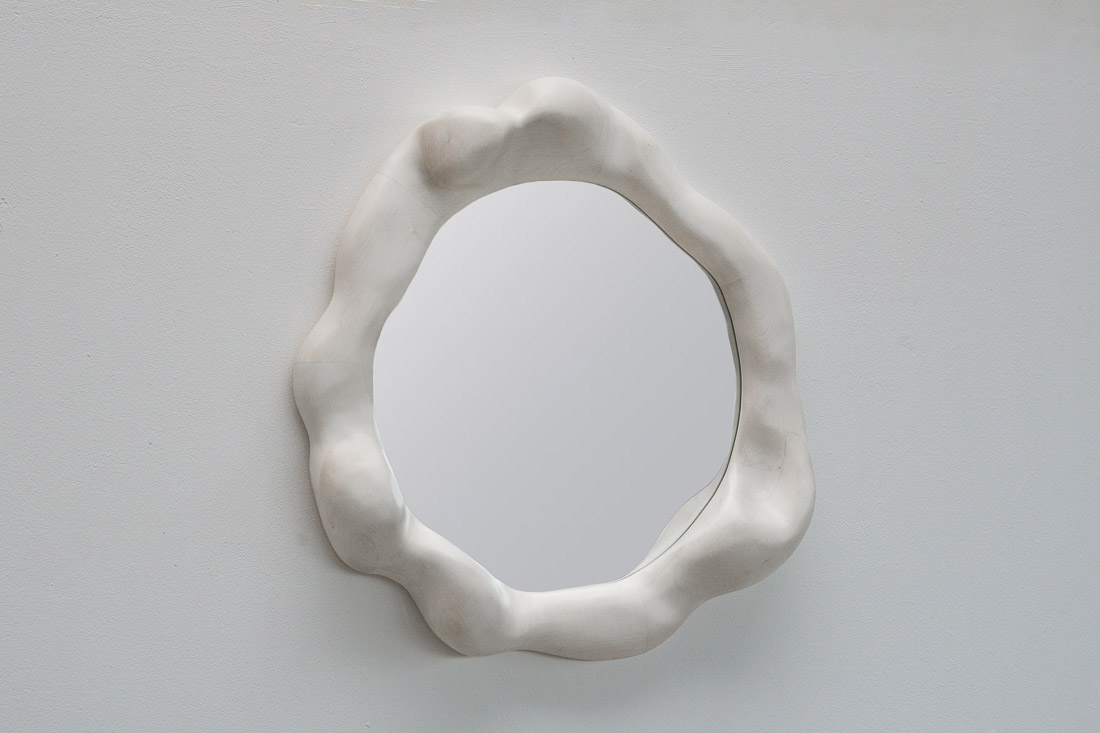 sculptural mirror in bleached maple