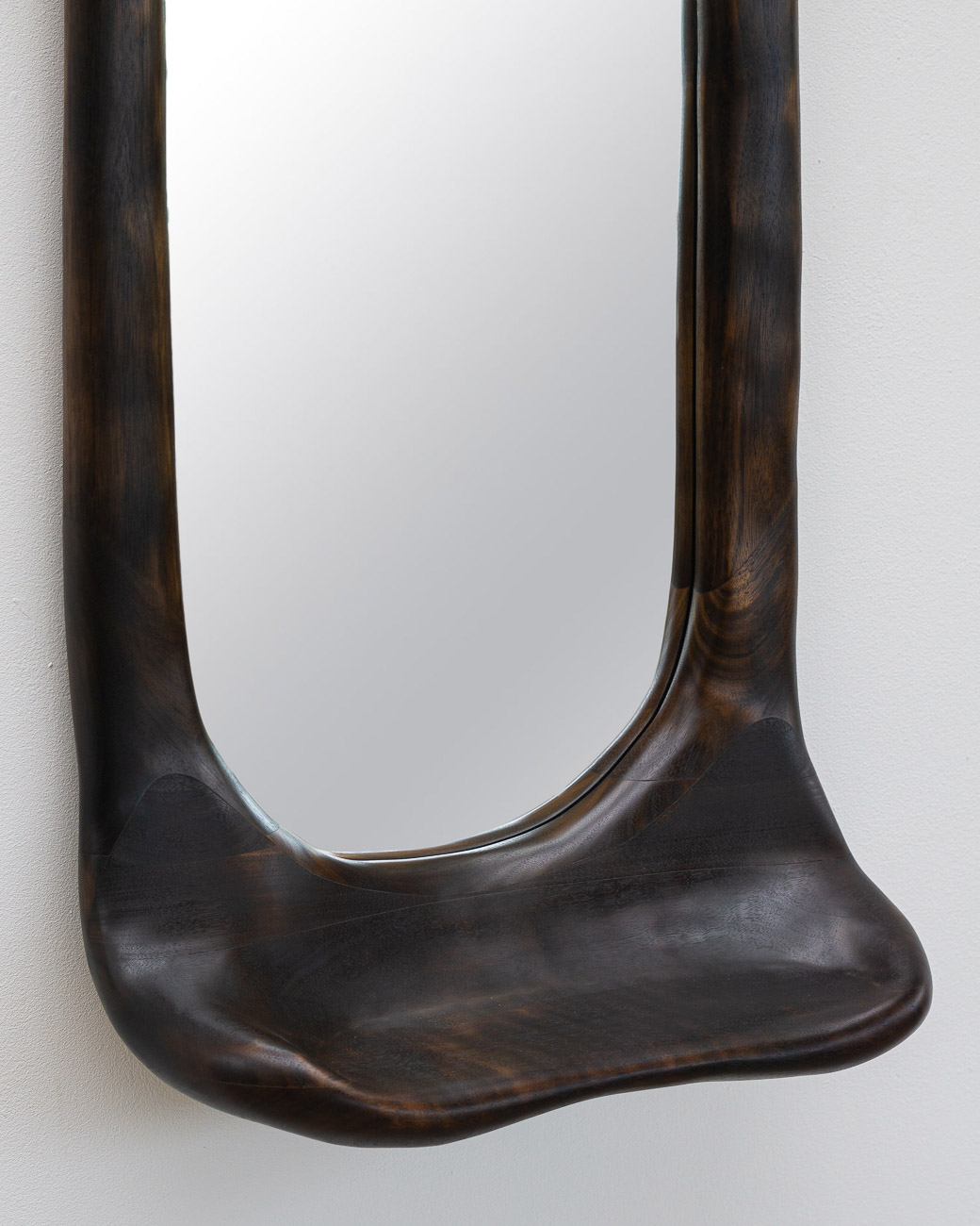 sculptural mirror with shelf in charred walnut