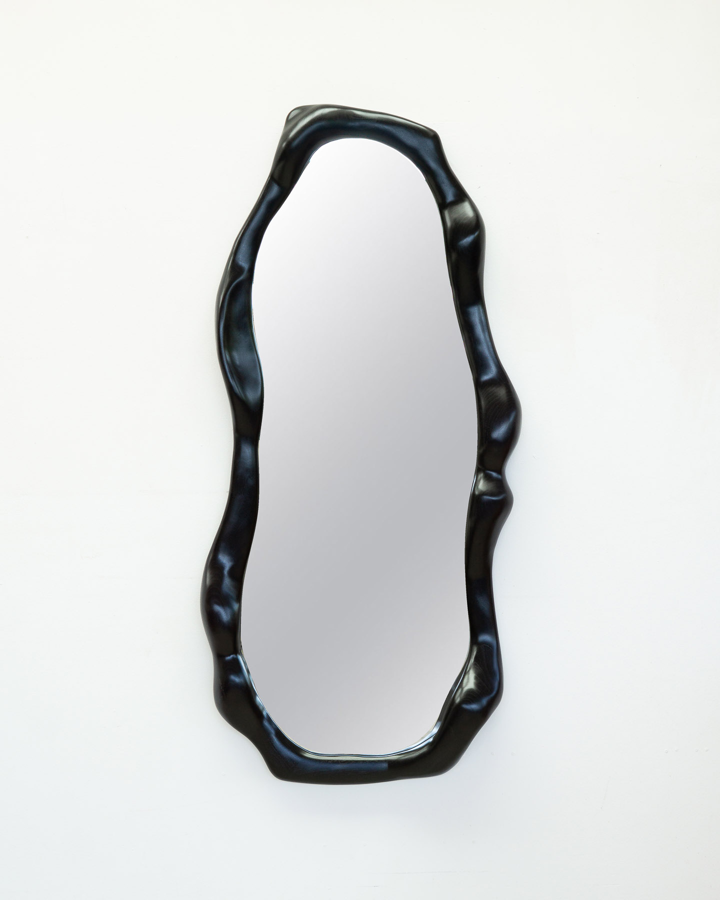sculptural mirror in ebonized walnut