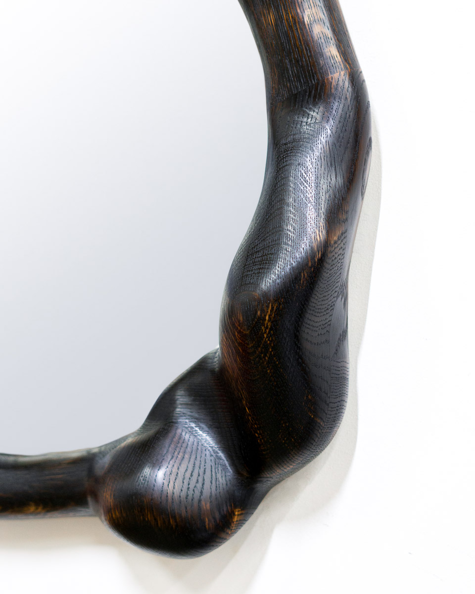 wavy mirror in charred oak