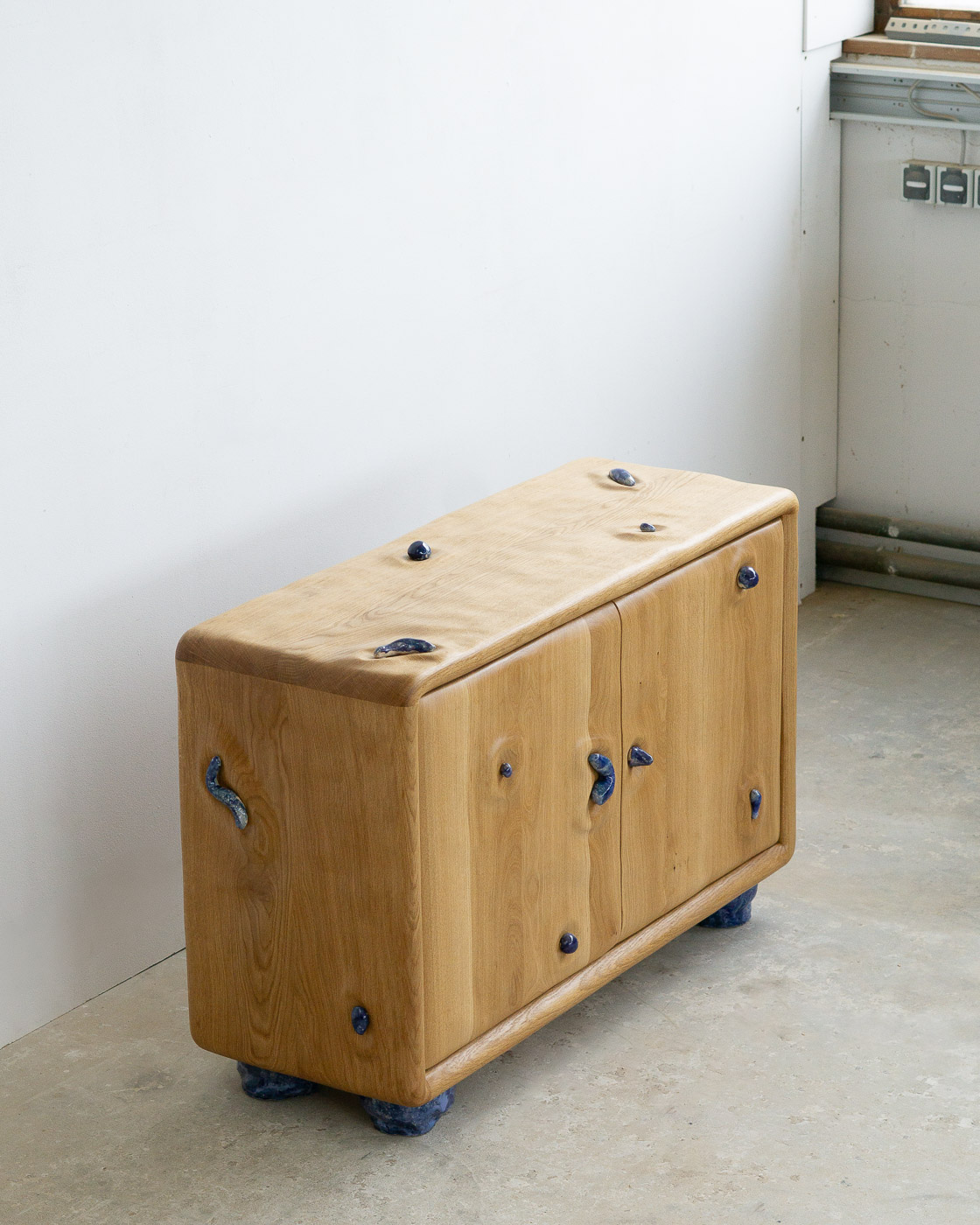 credenza in white oak with blue ceramic inlays